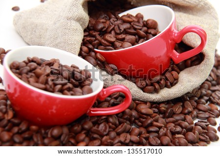 coffee beans in ceramic red coffee cups