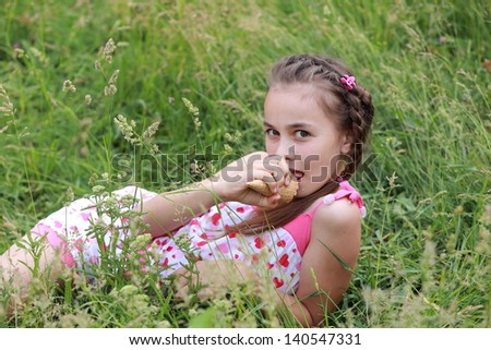 Cute young girl in casual clothes eat ice cream on the nature on Food and Drink