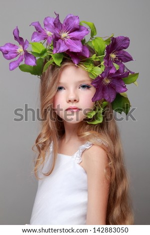 Little girl with makeup and hairstyle with beautiful flower
