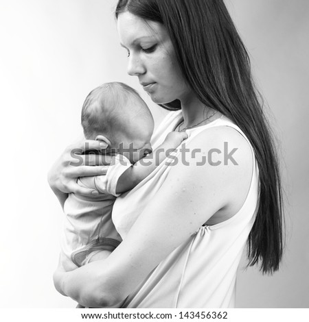 beautiful mother holding baby boy/tender mother love