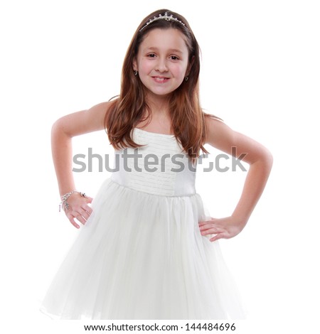 Studio image of a young ballerina in white dress standing on pointe on white background
