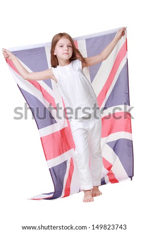 British young girl with a sweet smile, holding a flag of the United Kingdom isolated on white