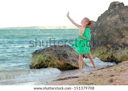 Greek goddess of the ancient amphora/Beautiful young girl in tunic, barefoot on the beach at sunset