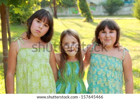 funny happy little girls fool around in the park