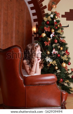 Caucasian princess with christmas presents near the fur-tree/Little cute girl on Christmas time