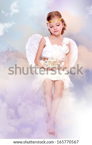 Little angel on the cloud holding lovely house on Holiday theme