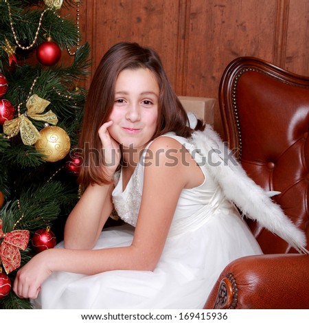 Cute home portrait of beautiful little girl as an angel over Christmas decoration on Holiday theme/Christmas - Cute little Angel