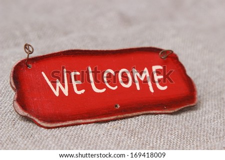 word welcome over canvas background/Welcome sign on wooden fence