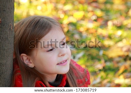 Nice portrait of cheerful cute young girl in the park/Image of pretty and beautiful face of lovely european little girl in autumn season