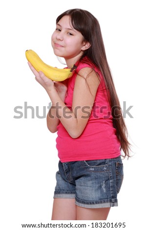 Caucasian happy girl holds a bunch of bananas