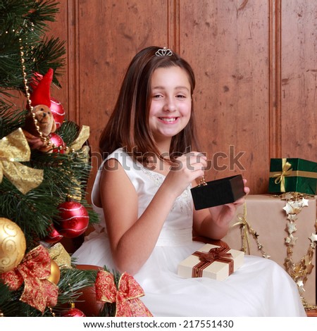 Happy smiley little girl over christmas decoration on Holiday theme/Happy little girl with Christmas gifts