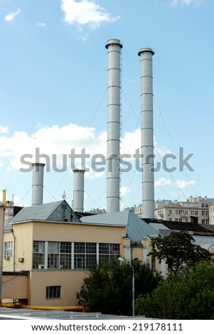 Old factory chimneys against the blue sky