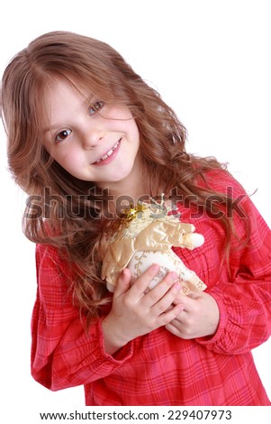 Studio portrait of beautiful little angel holding lovely angel doll and sitting on a cloud isolated over white background on Holiday theme