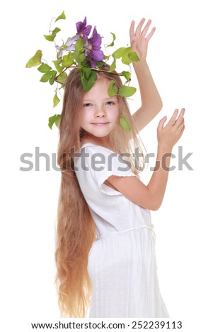 Pretty cute little girl with a sweet smile with hair fresh clematis on Beauty and Fashion