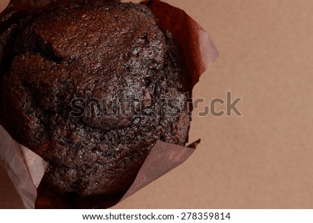 chocolate muffin over dark wallpaper texture