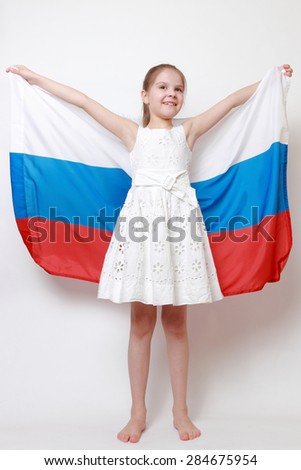 Beautiful little girl holding national flag of Russian Federation (Russia)