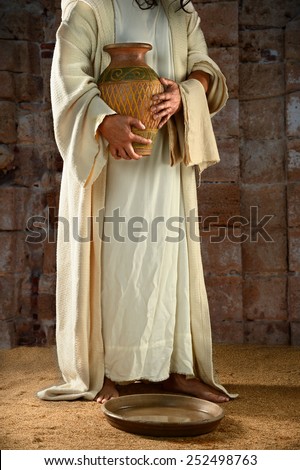 Jesus standing and holding water jar ready to wash the disciples' feet