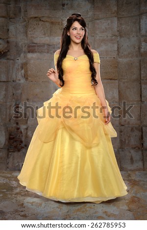 Portrait of beautiful young woman dressed in princess costume inside castle