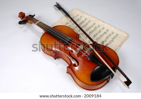 Old violin with vintage music sheet
