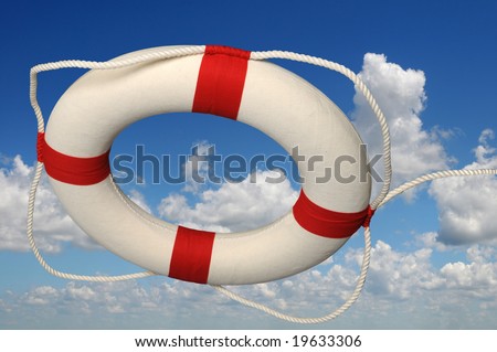Life preserver with rope against a sky