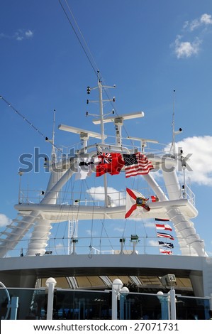 Cruise ship tower with the British Red Ensign, flags of the United States and the state of Florida.