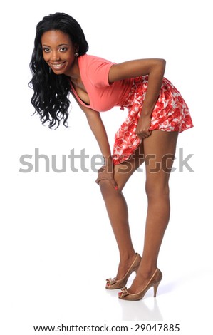 Young African American woman with skirt and high heels isolated over white