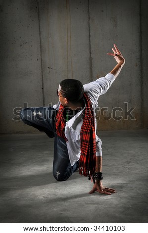 African American hip hop dancer performing over grunge background
