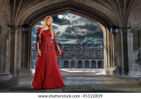 Beautiful Renaissance woman holding rose in ancient building