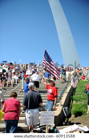 SAINT LOUIS, MISSOURI - SEPTEMBER 12: Man holding flag at rally of the Tea Party Patriots in Downtown Saint Louis under the Arch, on September 12, 2010