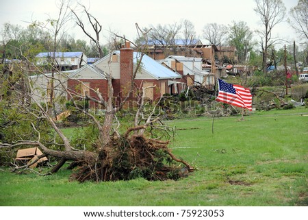 SAINT LOUIS, MISSOURI - APRIL 24: A US flag flies amidst damaged homes  after tornadoes hit the Bridgeton area on Friday April 22, 2011 in Saint Louis, Missouri.