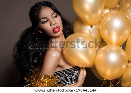 woman with many golden balloons