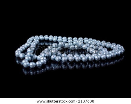 string of blue pearls isolated on black with reflection