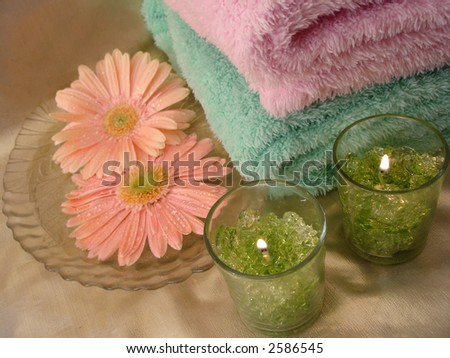Spa essentials (green candles and towels with flowers)
