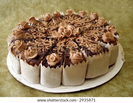 chocolate cake with flowers on textured background