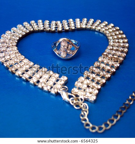 diamond necklace with ring on blue background