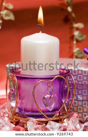 violet candle with heart and gift box