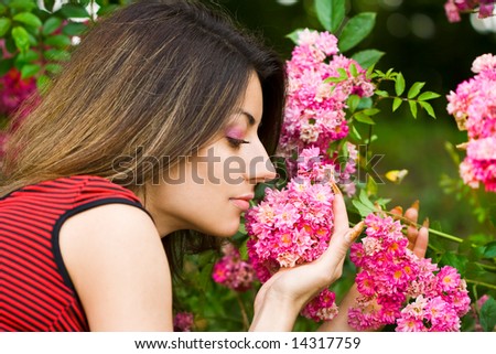 beautiful girl smells pink flowers
