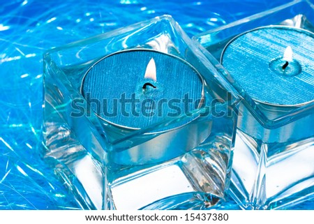 blue candles in glass with water