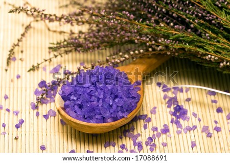 Spa essentials (bath salt in a spoon and flowers of lavender)
