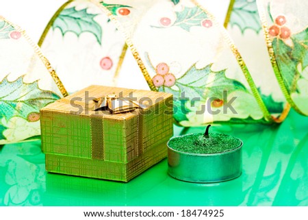 golden gift box and burning candle