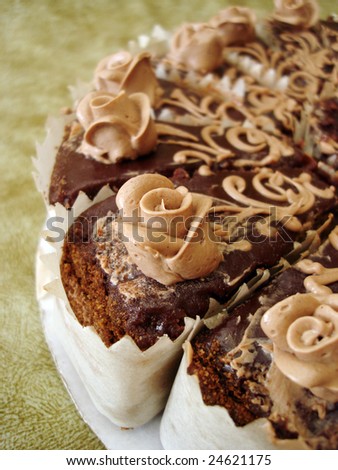 chocolate cake with flowers on textured background