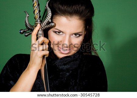 woman with daggers on green background