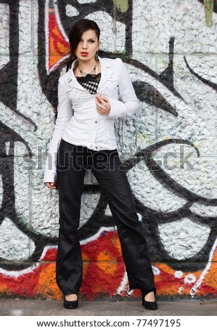 girl near the wall with graffiti
