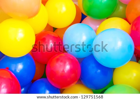 Balloons of many colours in a large pile
