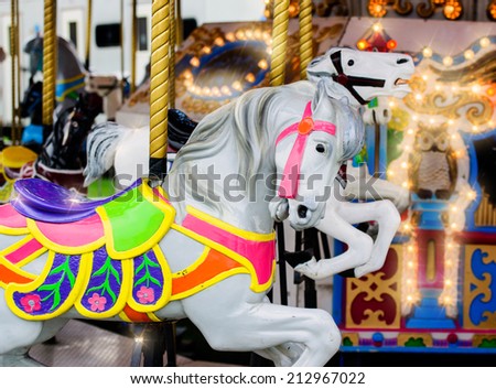 A close up of a merry-go-round horse on a carousel ride at an amusement park.