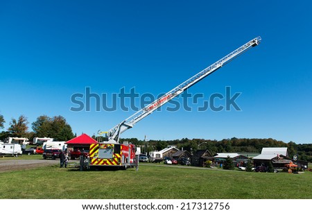 BRACEBRIDGE, CANADA - September 14, 2013: A fire truck with an extended ladder at the 146th annual Bracebridge Fall Fair and Horse Show.