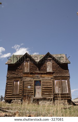 Old log house with Victorian era trim on top, in Cripple Creek, Co., taken May, 2005.