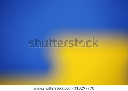 Blue and Yellow defocused background. The blue is in the upper left part. The yellow is in the lower right part. The two colored part have an L letter  shape.