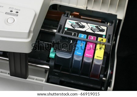 Detail of computer printer ink cartridges with separate units in carrier.