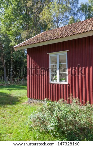 Red little cottage in the woods